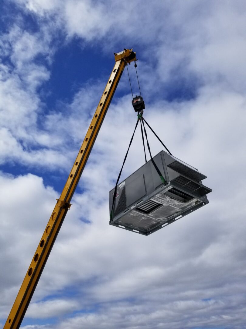 A crane lifting a large piece of metal.